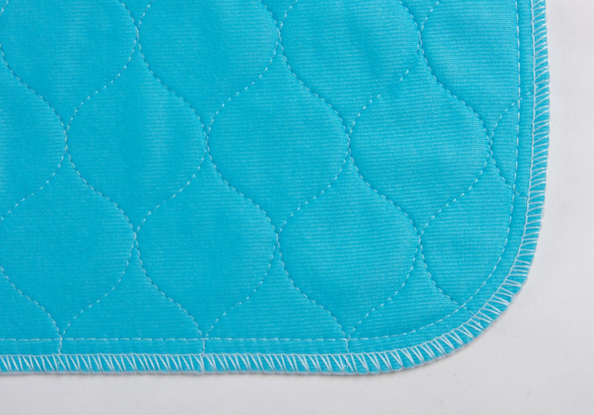 A close up image of the corner of a Pet Impact washable puppy pad.