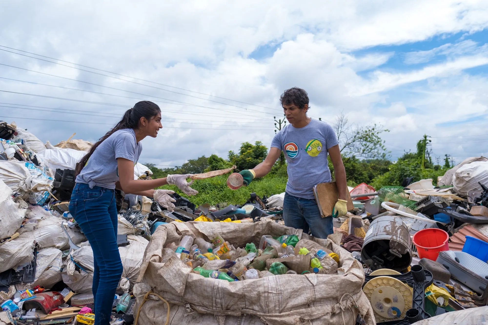 An image of people picking up plastic bottles and rubbish
