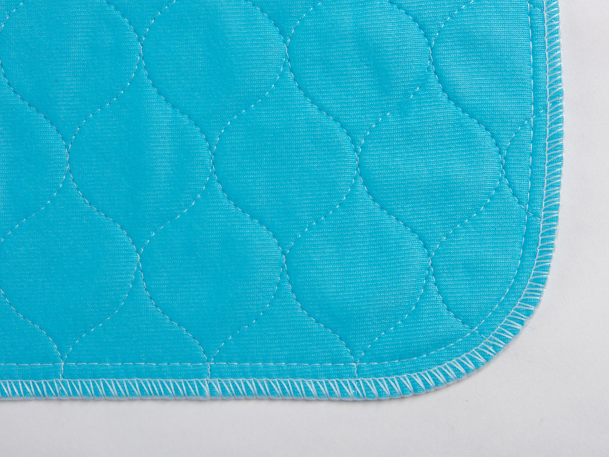 A close up image of the corner of a Pet Impact washable puppy pad.