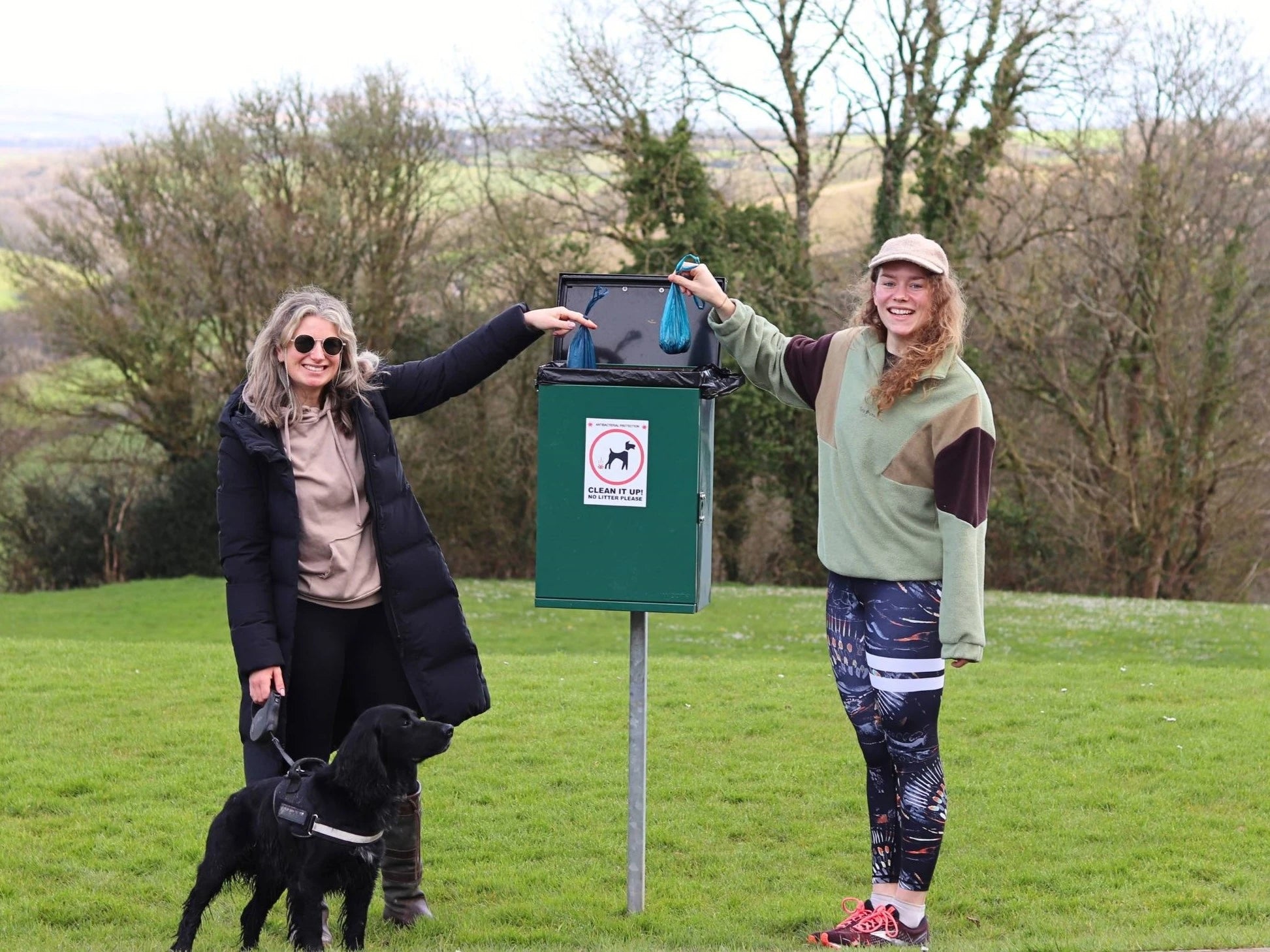 An image of Abbi and Alice putting ReSEAcled poo bags in the bin