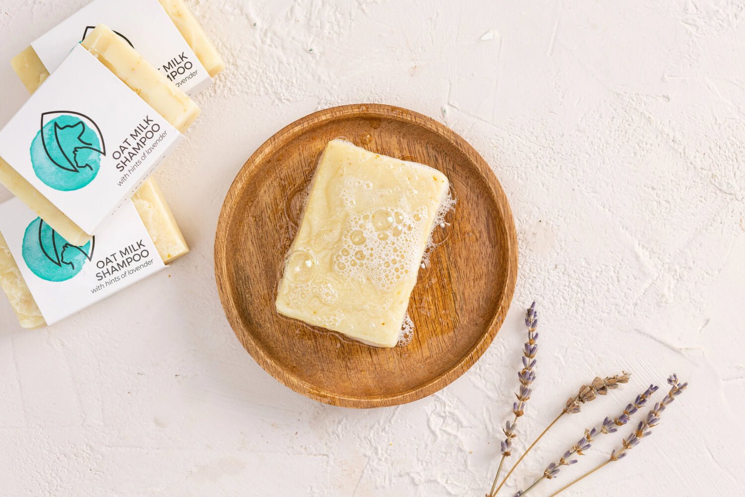 A lifestyle image of a dog shampoo bar on a wooden tray