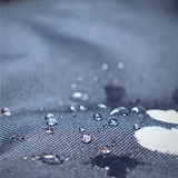 Rain droplets beading on a dog walking bag